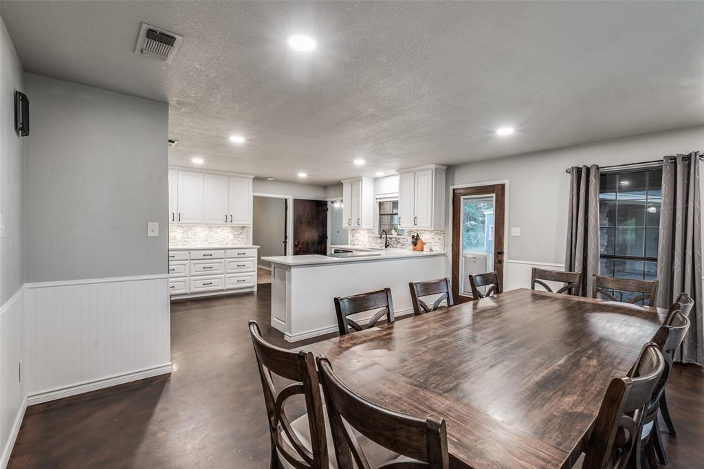 131 Cunningham Road Denton, TX 76208 - Photo 14 of 40 a kitchen with a dining table chairs and refrigerator