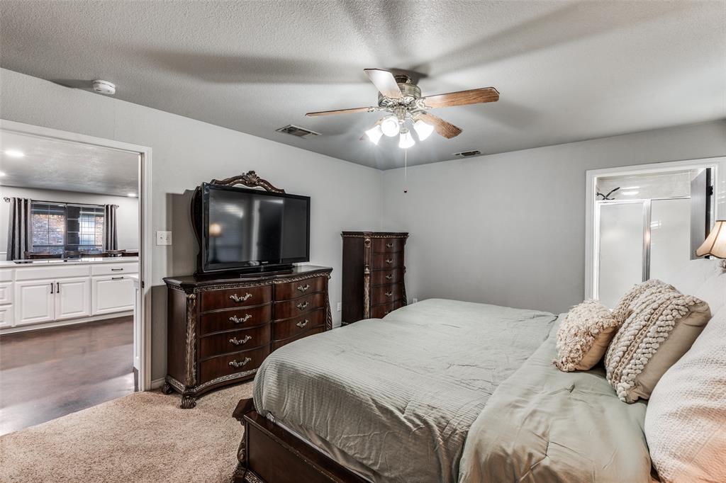 131 Cunningham Road Denton, TX 76208 - Photo 17 of 40 a bedroom with a bed and a flat screen tv