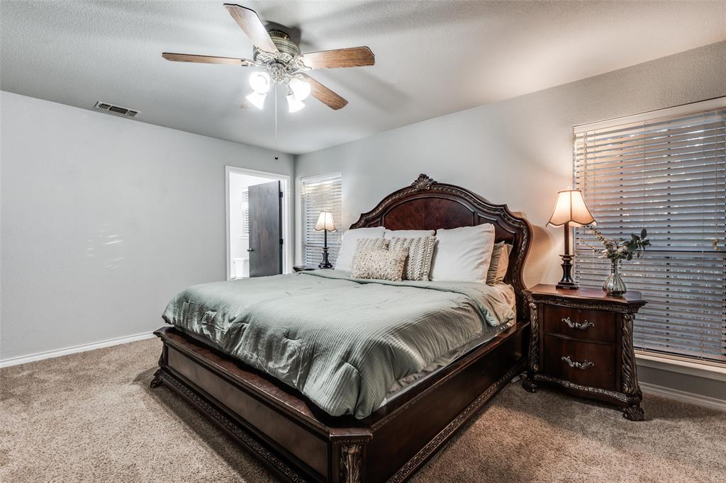 131 Cunningham Road Denton, TX 76208 - Photo 19 of 40 a bedroom with a bed and ceiling fan