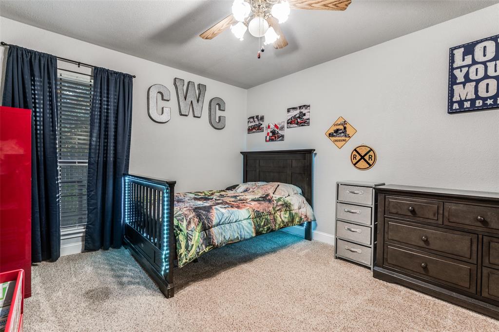 131 Cunningham Road Denton, TX 76208 - Photo 23 of 40 a bedroom with a bed and a window