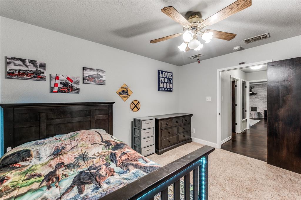 131 Cunningham Road Denton, TX 76208 - Photo 24 of 40 a bedroom with a bed and a dresser