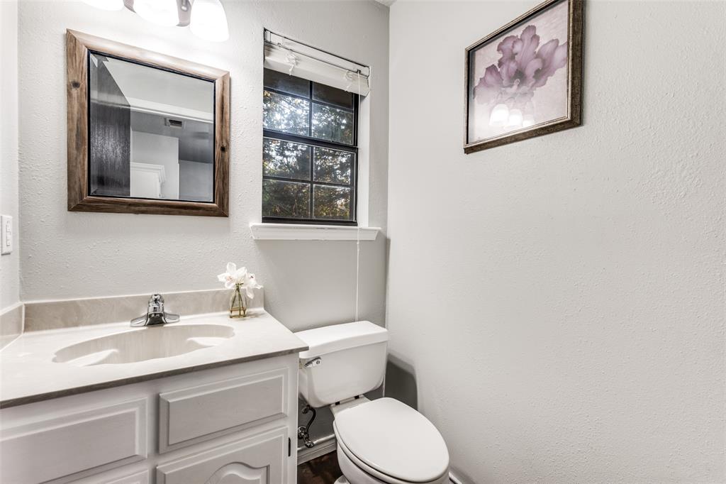131 Cunningham Road Denton, TX 76208 - Photo 31 of 40 a bathroom with a toilet sink and mirror