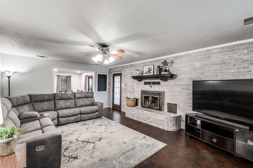 131 Cunningham Road Denton, TX 76208 - Photo 7 of 40 a living room with furniture flat screen tv and a fireplace