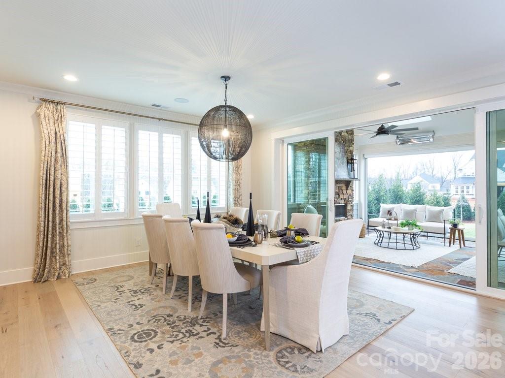 110 Willow Vw Loop Davidson, NC 28036 - Photo 12 of 42 a view of a dining room with furniture wooden floor and a chandelier