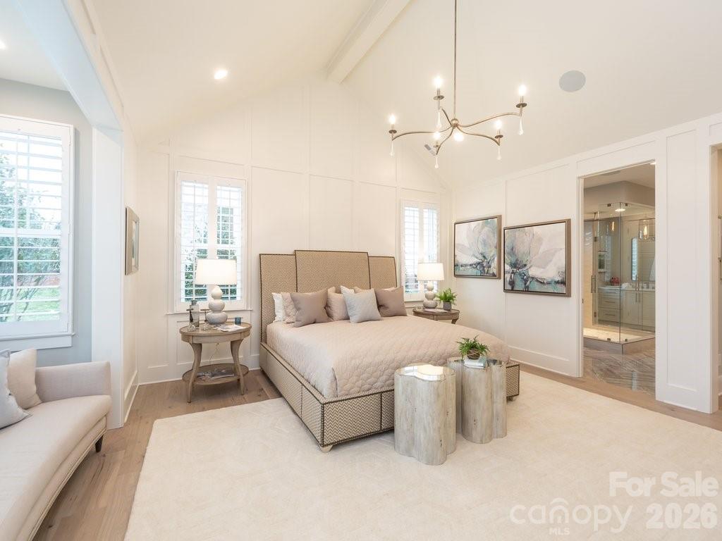 110 Willow Vw Loop Davidson, NC 28036 - Photo 23 of 42 a spacious bedroom with a bed a couch and large window