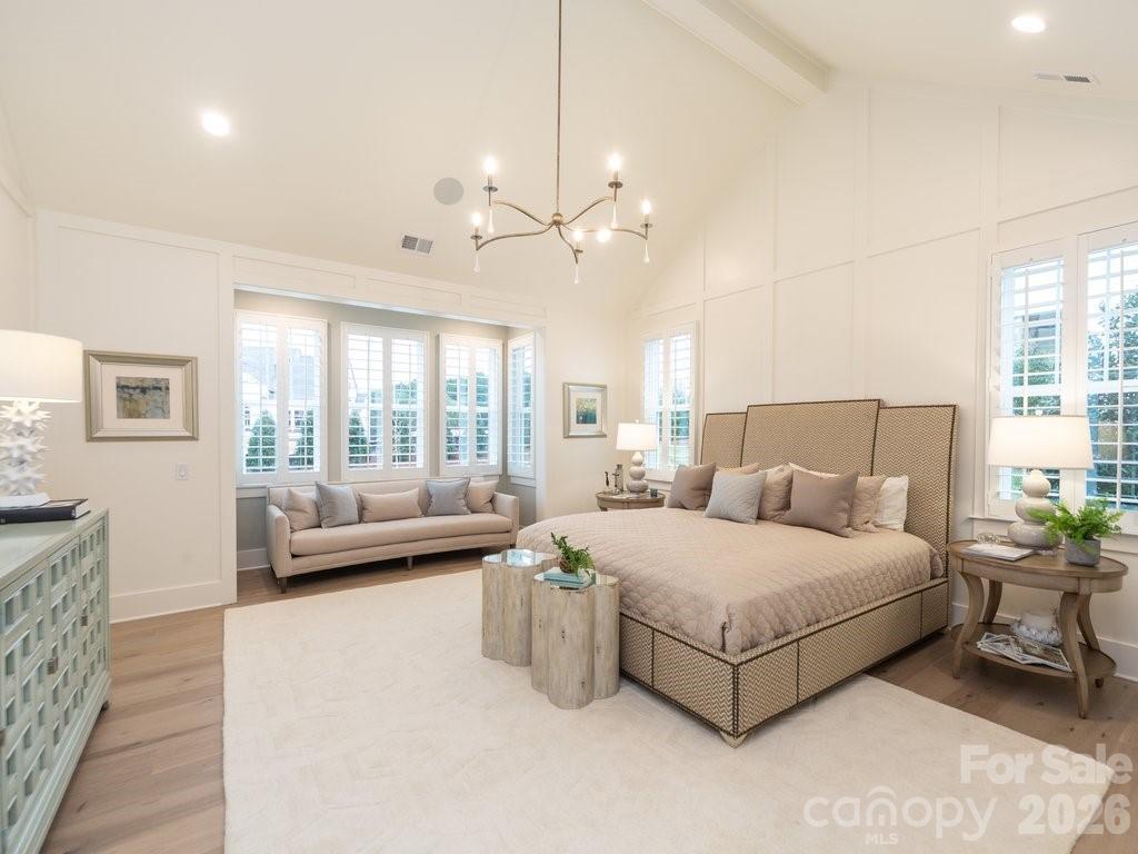 110 Willow Vw Loop Davidson, NC 28036 - Photo 24 of 42 a bedroom with a large bed and a chandelier