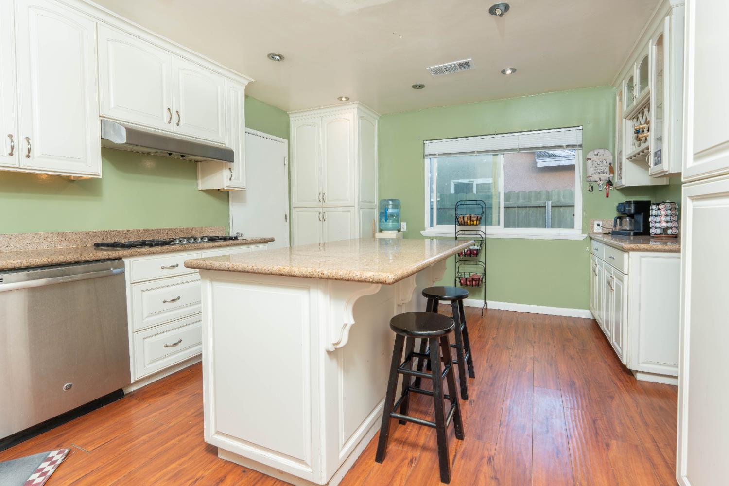 1574 Bluejay Circle Hanford, CA 93230 - Photo 11 of 23 a kitchen with stainless steel appliances white cabinets and wooden floors