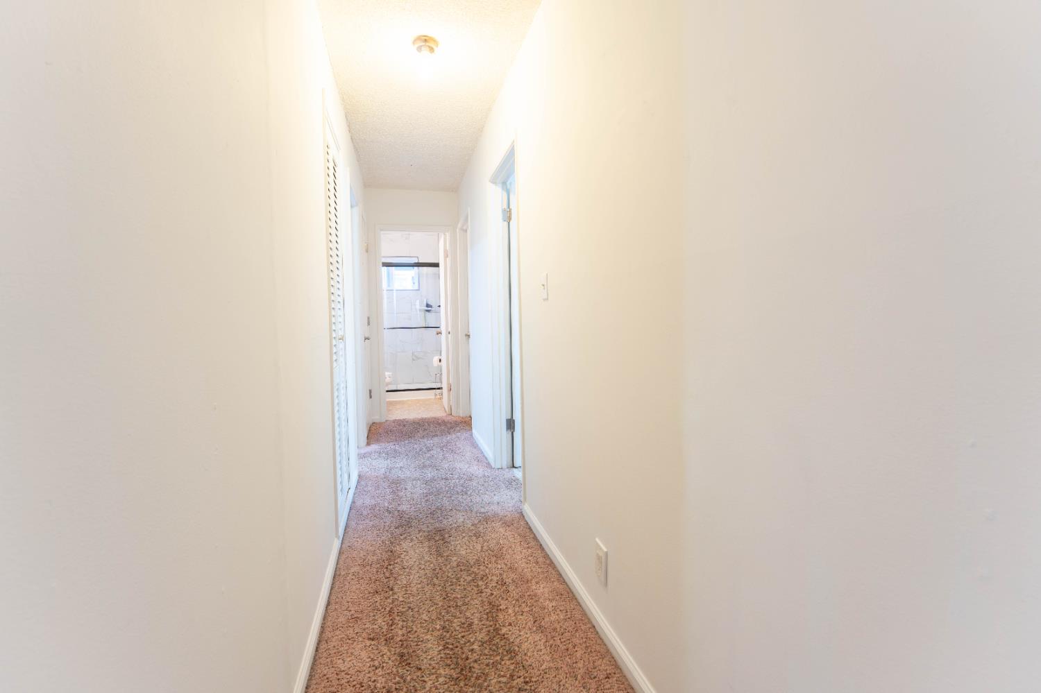 1574 Bluejay Circle Hanford, CA 93230 - Photo 13 of 23 a view of a hallway with wooden floor