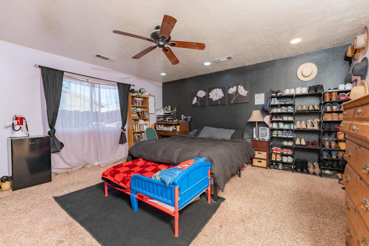 1574 Bluejay Circle Hanford, CA 93230 - Photo 14 of 23 a bed room with a bed window and a book shelf