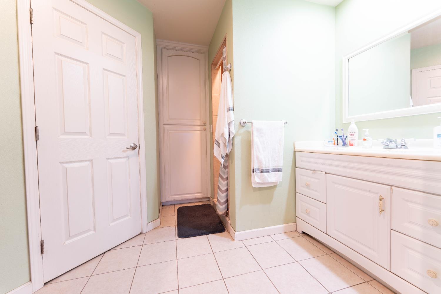 1574 Bluejay Circle Hanford, CA 93230 - Photo 16 of 23 a bathroom with a sink and a mirror