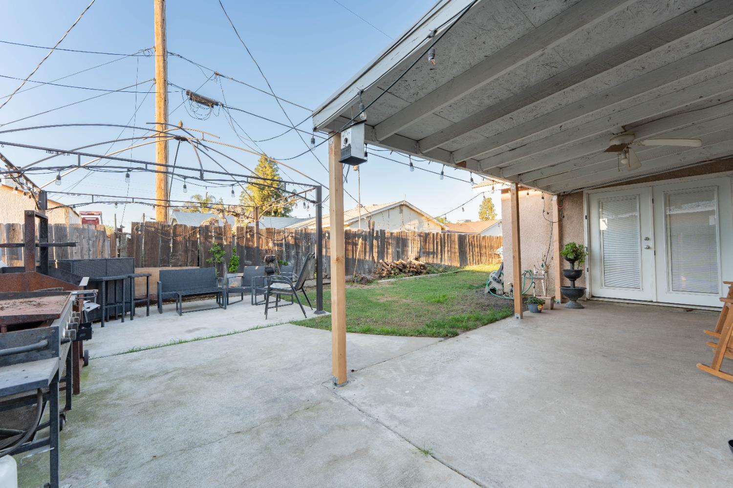 1574 Bluejay Circle Hanford, CA 93230 - Photo 21 of 23 a view of a porch with table and chairs and potted plants
