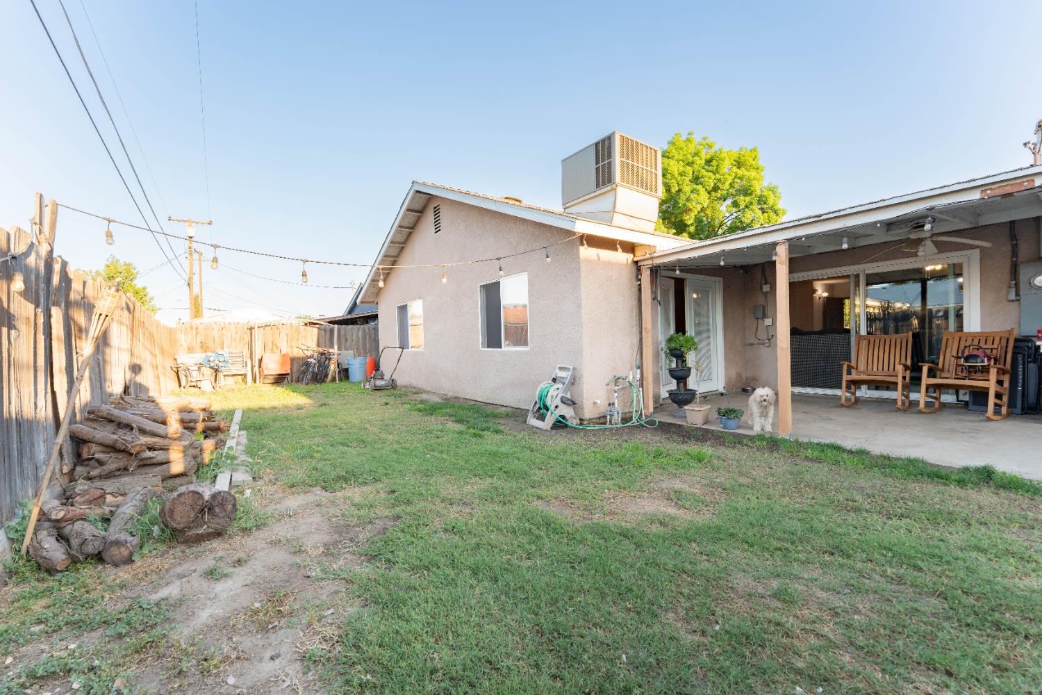 1574 Bluejay Circle Hanford, CA 93230 - Photo 22 of 23 a view of a backyard with table and chairs and potted plants