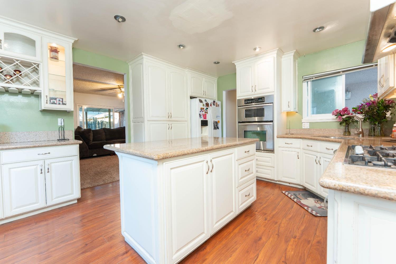 1574 Bluejay Circle Hanford, CA 93230 - Photo 10 of 23 a large kitchen with stainless steel appliances kitchen island granite countertop a stove and a sink