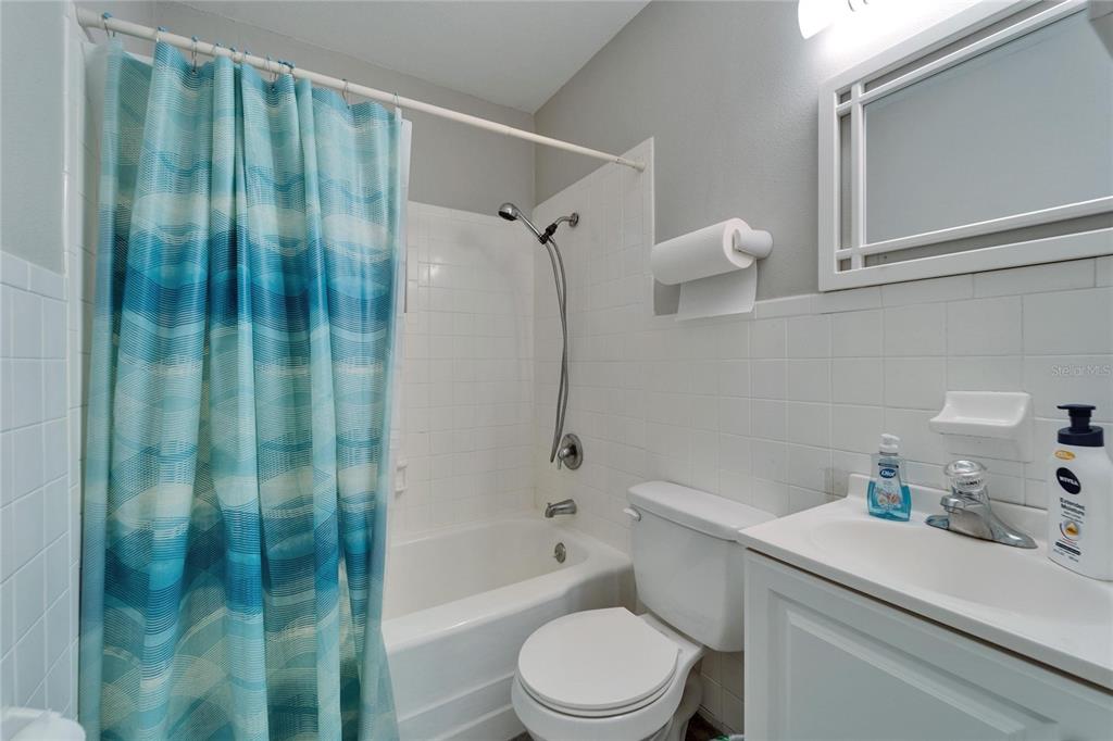 126 Ridgewood Avenue Brandon, FL 33510 - Photo 26 of 85 a bathroom with a sink a toilet and shower