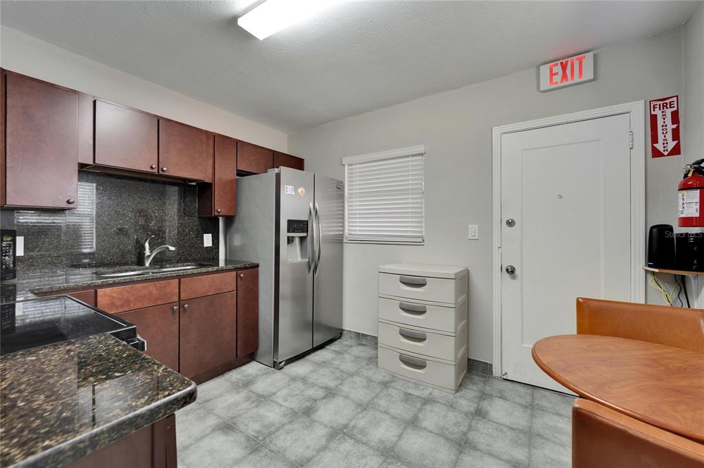 126 Ridgewood Avenue Brandon, FL 33510 - Photo 31 of 85 a kitchen with stainless steel appliances granite countertop a refrigerator and a stove top oven