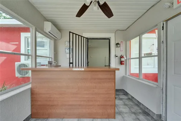 a room with gym equipment and wooden floor