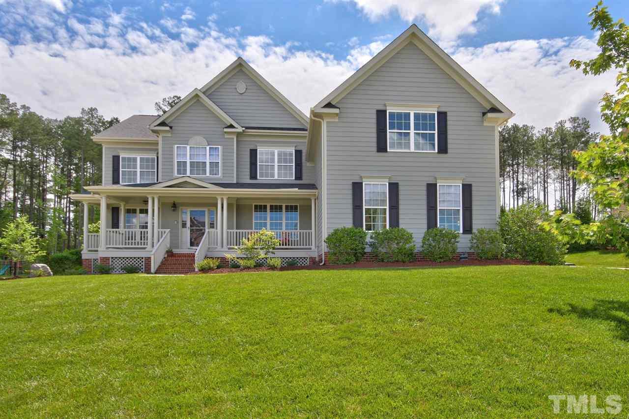 a front view of a house with a garden and porch