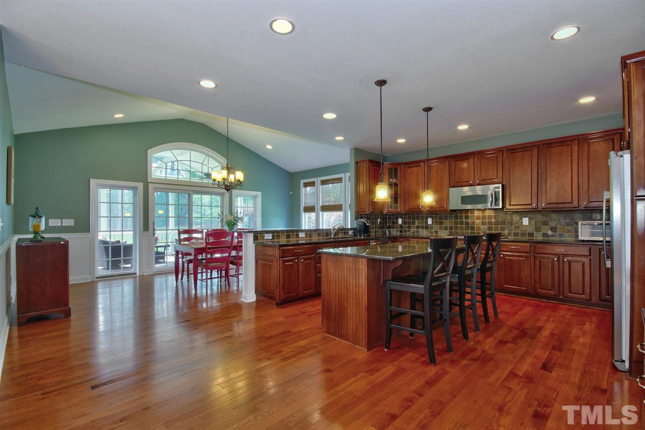 209 Bridle Boast Road Cary, NC 27519 - Photo 11 of 25 a kitchen with lots of counter space dining table and chairs