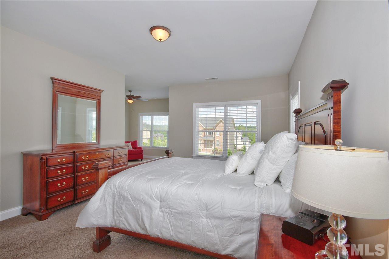 209 Bridle Boast Road Cary, NC 27519 - Photo 17 of 25 a bedroom with a bed and wooden floor