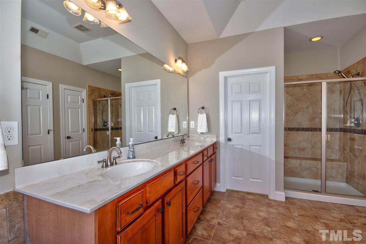 209 Bridle Boast Road Cary, NC 27519 - Photo 18 of 25 a bathroom with a sink double vanity and a shower