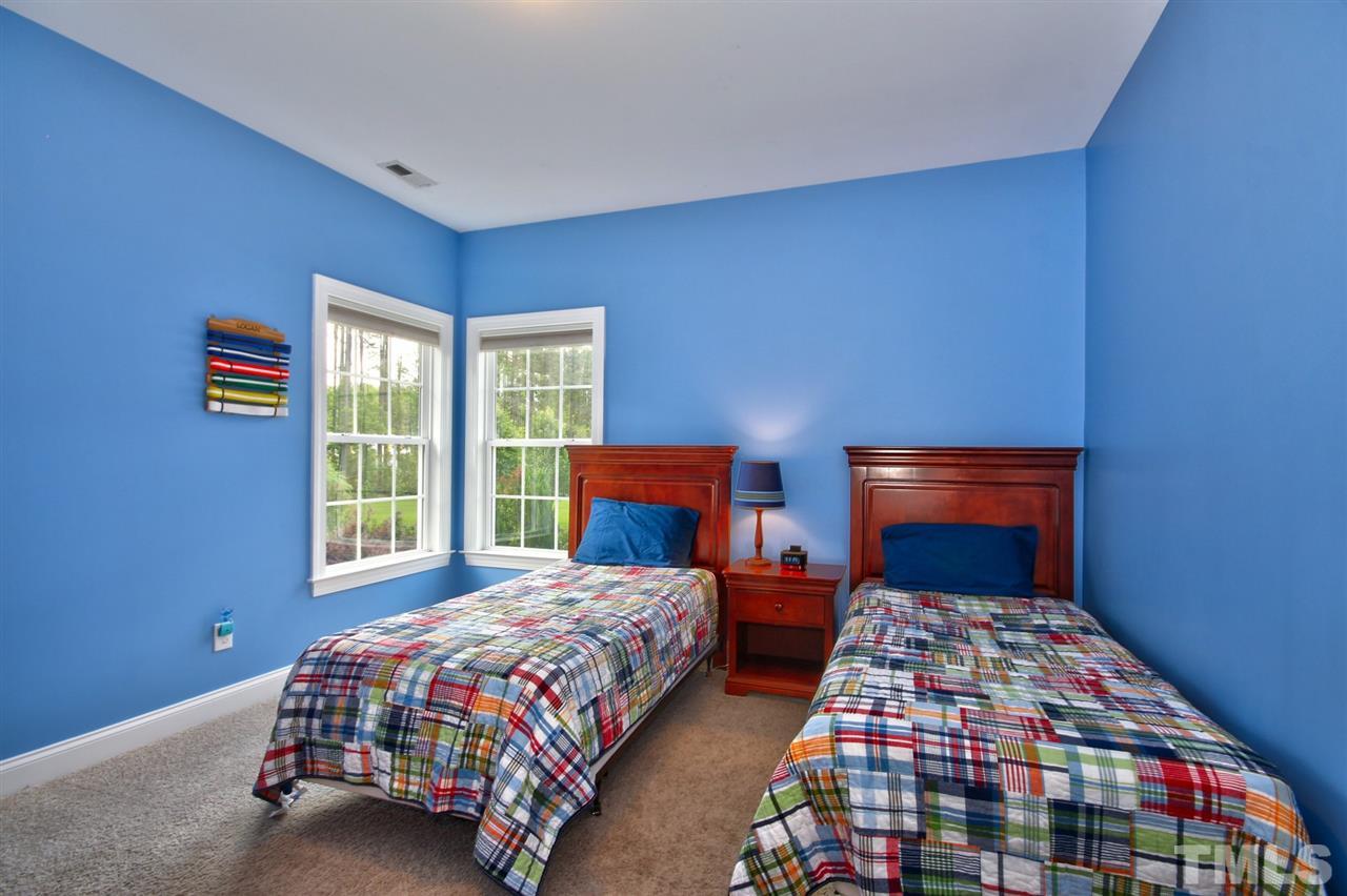 209 Bridle Boast Road Cary, NC 27519 - Photo 20 of 25 a bedroom with two beds lamp and a small window