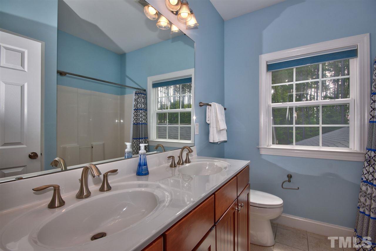 209 Bridle Boast Road Cary, NC 27519 - Photo 21 of 25 a bathroom with a granite countertop sink and a large mirror