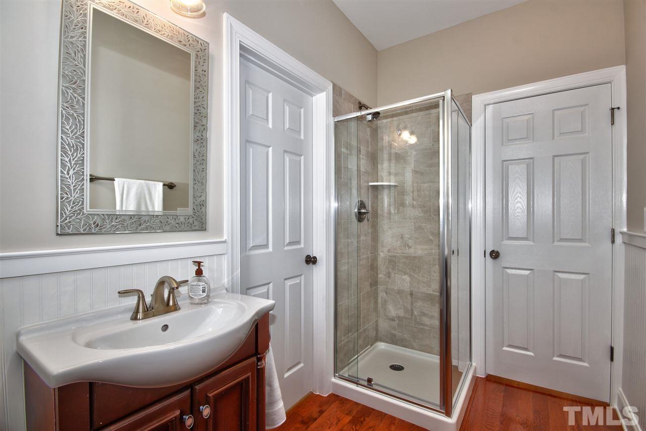 209 Bridle Boast Road Cary, NC 27519 - Photo 8 of 25 a bathroom with a sink a mirror and shower