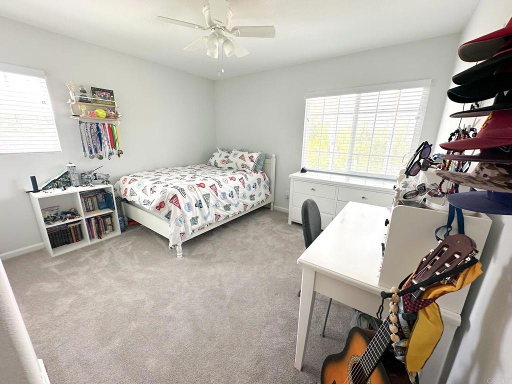 29824 Talitha Way Murrieta, CA 92563 - Photo 19 of 27 a bedroom with a bed table chair and window