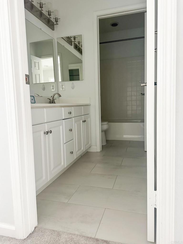 29824 Talitha Way Murrieta, CA 92563 - Photo 21 of 27 a spacious bathroom with a double vanity sink a mirror and a