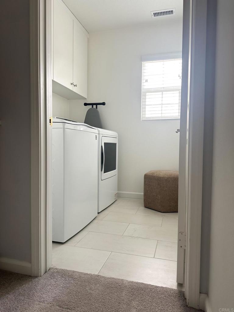 29824 Talitha Way Murrieta, CA 92563 - Photo 22 of 27 a kitchen with cabinets and white appliances