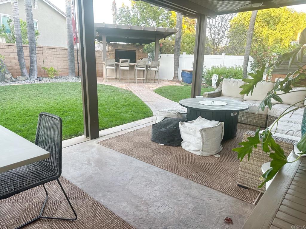 29824 Talitha Way Murrieta, CA 92563 - Photo 27 of 27 a view of a patio with table and chairs and floor to ceiling window
