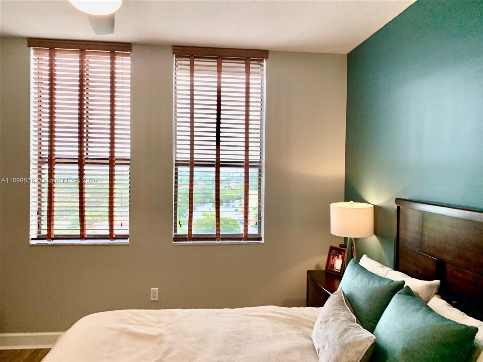 55 Merrick Way, Unit 730 Coral Gables, FL 33134 - Photo 12 of 23 a bedroom with a bed and wooden floor