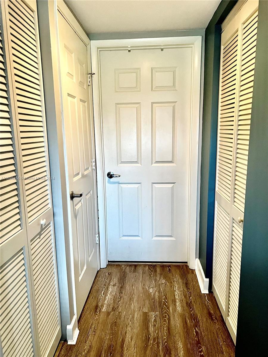 55 Merrick Way, Unit 730 Coral Gables, FL 33134 - Photo 15 of 23 a view of an empty room with wooden floor and a window
