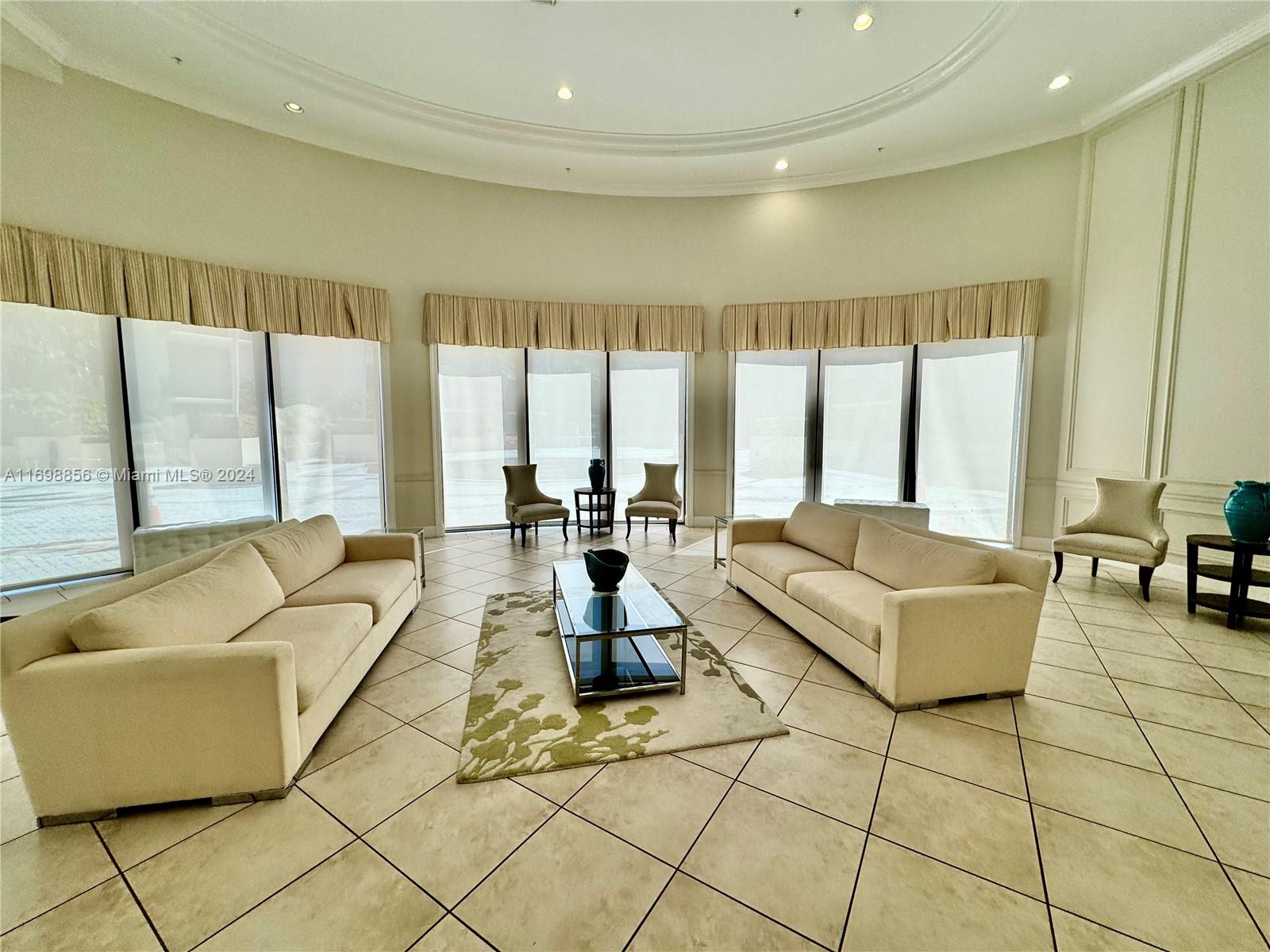 55 Merrick Way, Unit 730 Coral Gables, FL 33134 - Photo 19 of 23 a living room with fireplace furniture and floor to ceiling window