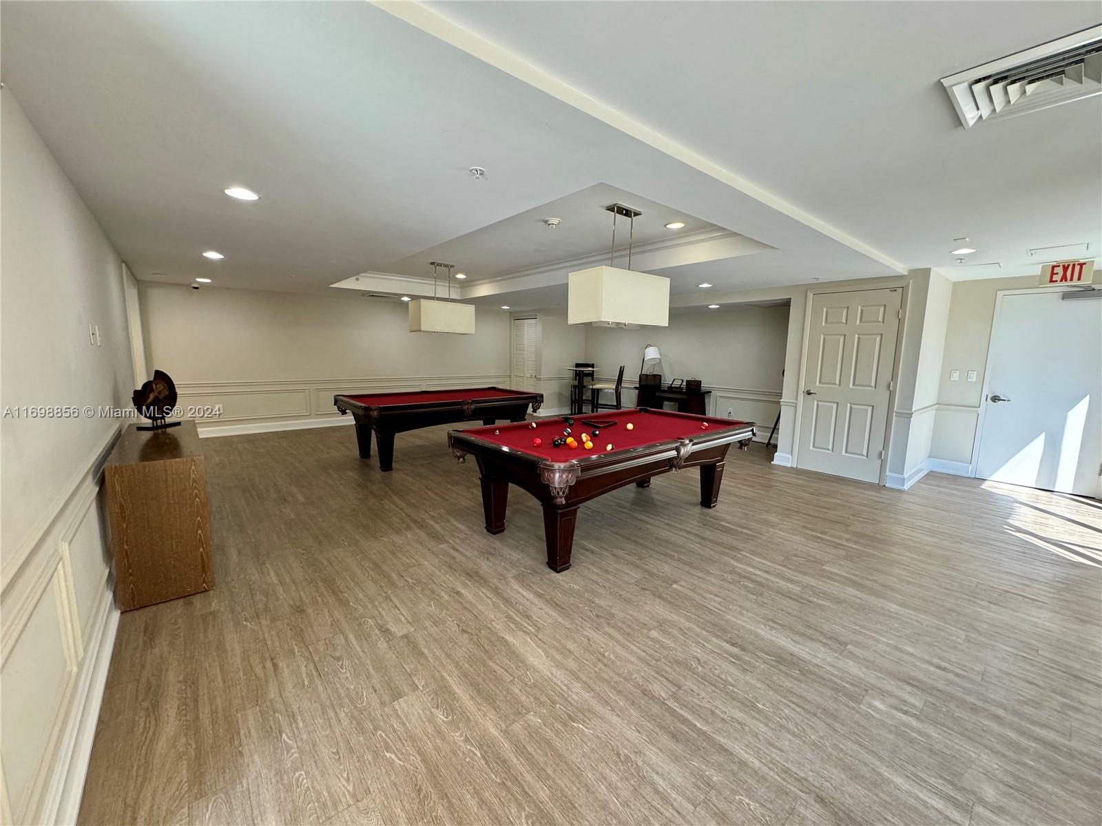 55 Merrick Way, Unit 730 Coral Gables, FL 33134 - Photo 21 of 23 a playing room with furniture and wooden floor