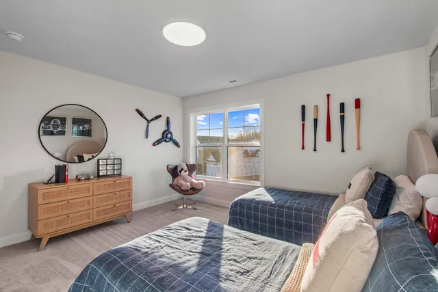 a bedroom with two beds and a window