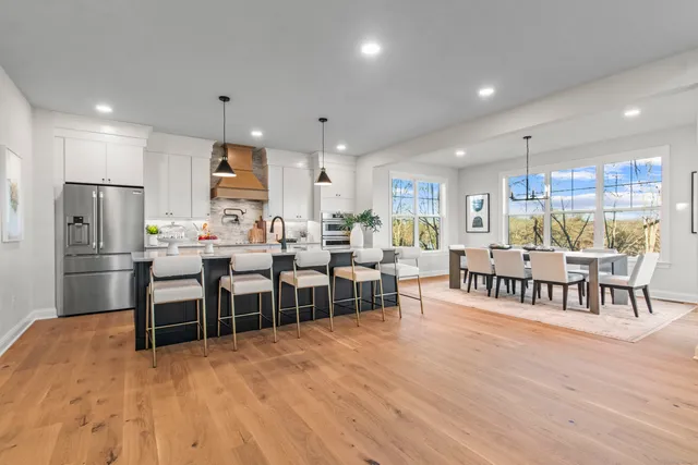 a living room with kitchen island furniture and a table