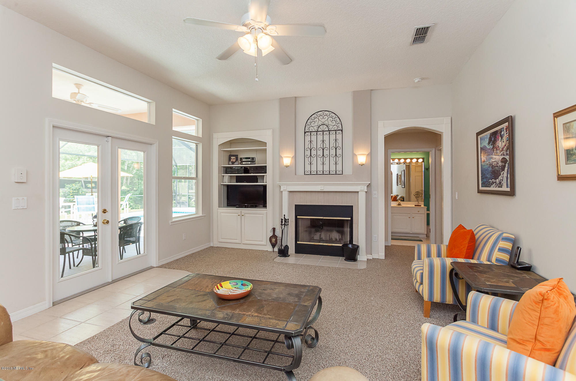 680 Roberts Road St. Johns, FL 32259 - Photo 16 of 45 a living room with furniture a fireplace and a flat screen tv