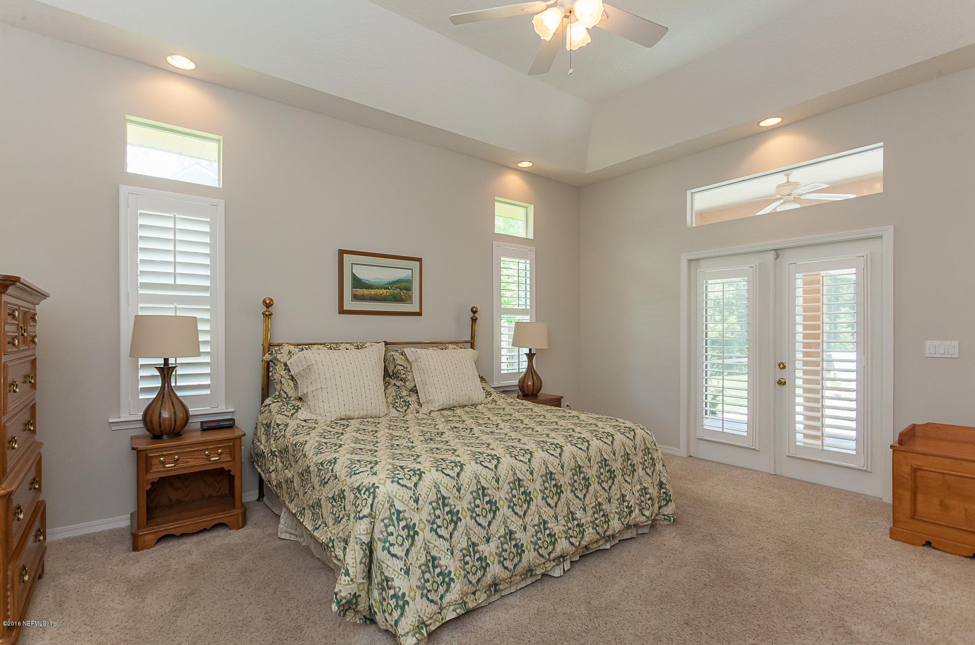 680 Roberts Road St. Johns, FL 32259 - Photo 18 of 45 a bedroom with a large bed and a chandelier