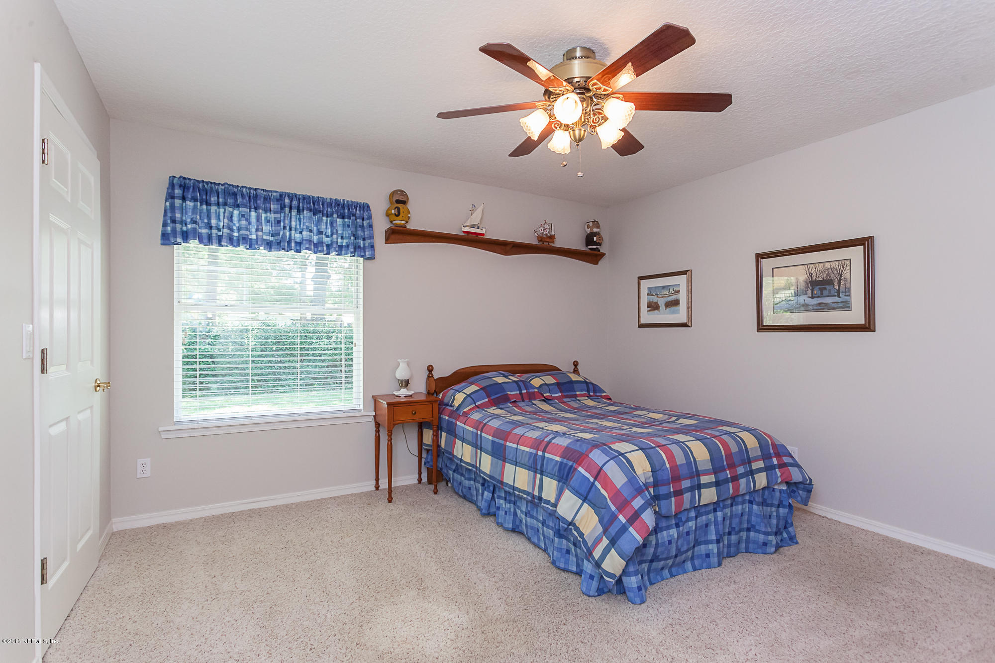 680 Roberts Road St. Johns, FL 32259 - Photo 27 of 45 a bedroom with a bed chandelier and a window