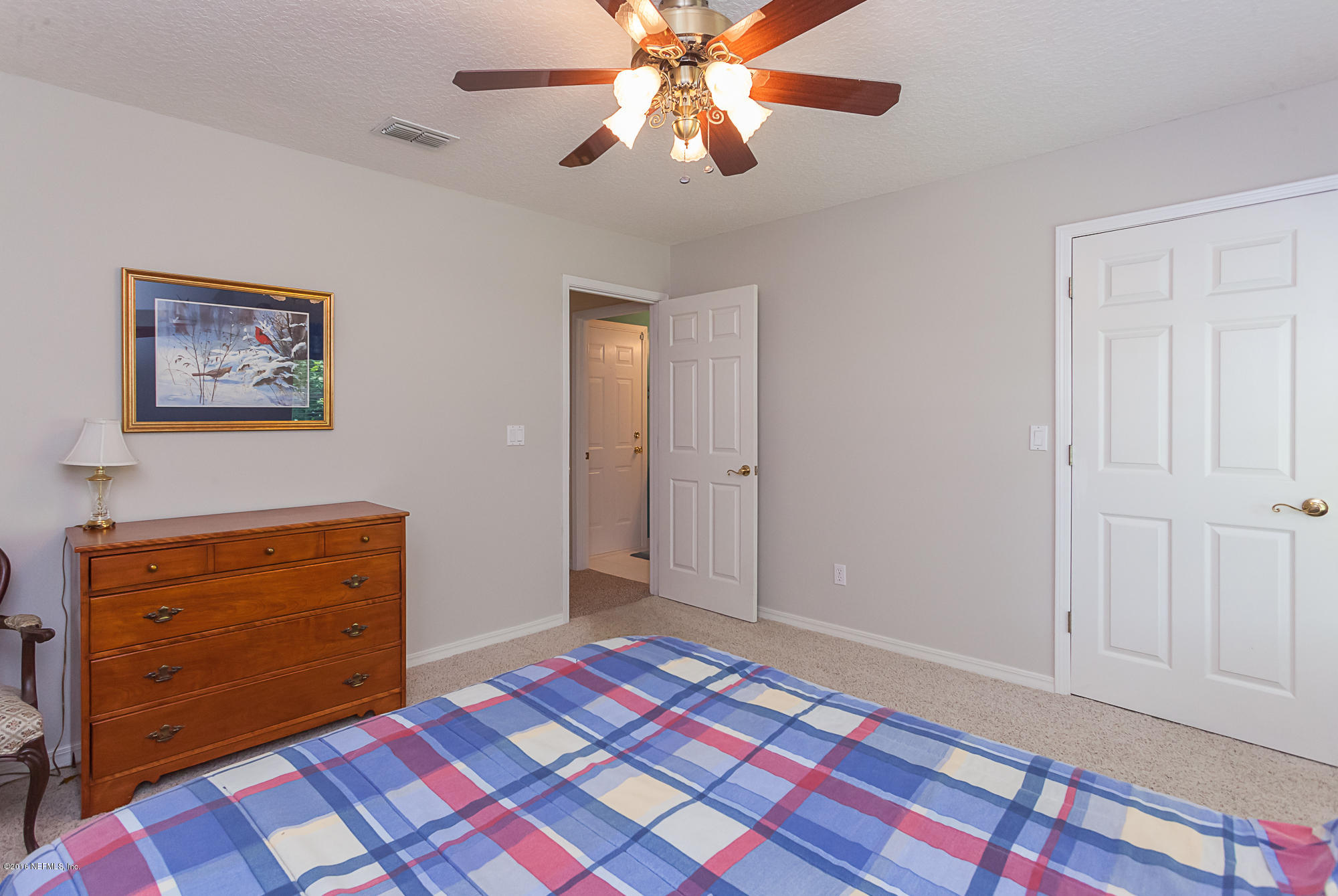 680 Roberts Road St. Johns, FL 32259 - Photo 28 of 45 a bedroom with a bed and a dresser in it