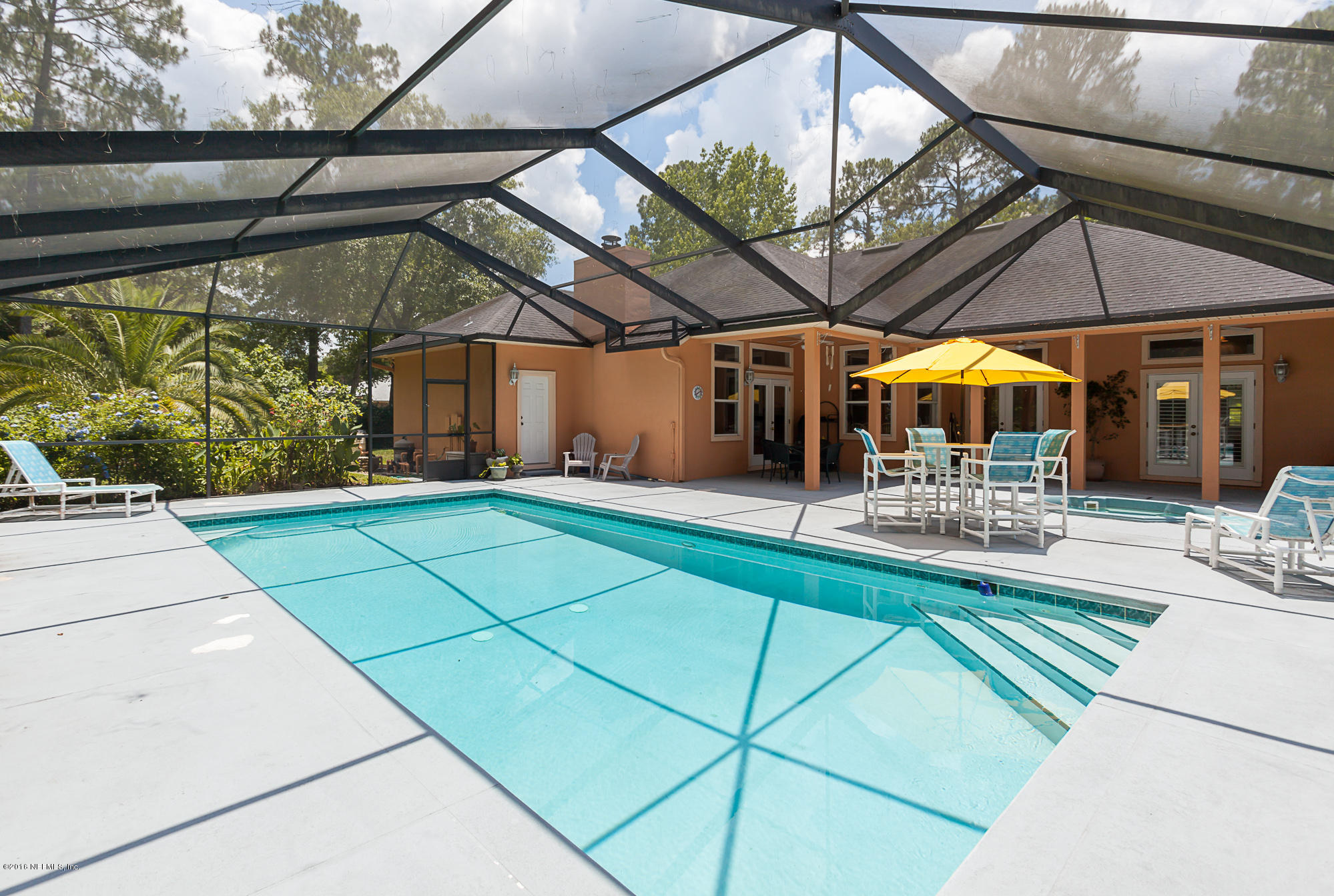 680 Roberts Road St. Johns, FL 32259 - Photo 34 of 45 a view of a patio with a table and chairs under an umbrella