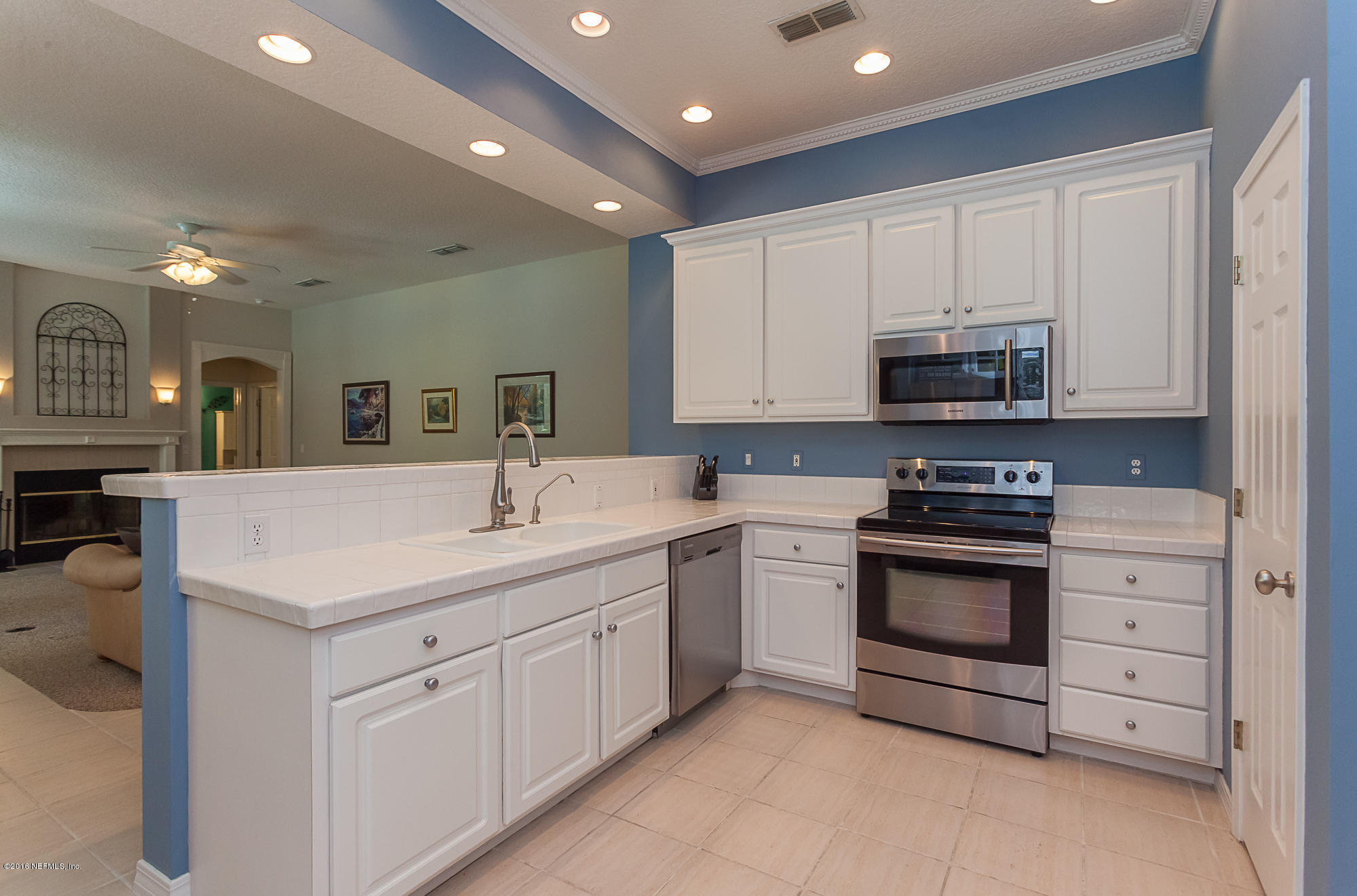 680 Roberts Road St. Johns, FL 32259 - Photo 10 of 45 a kitchen with stainless steel appliances granite countertop a sink stove and cabinets