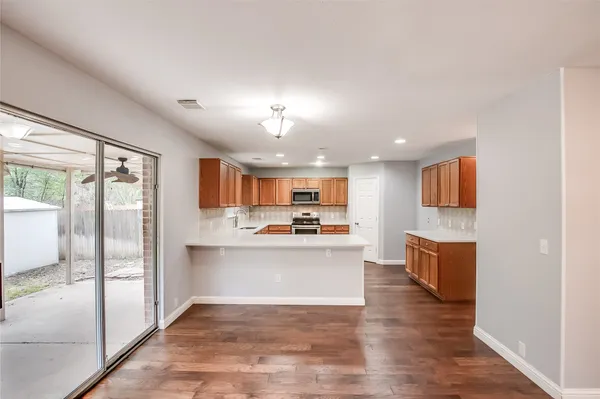 a view of kitchen with sink and refrigerator
