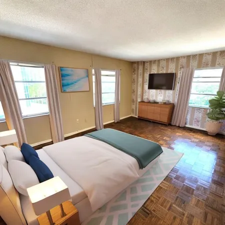 a bedroom with a bed and a large window