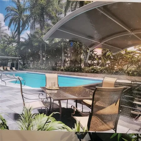 a view of a house with a yard and a sitting area