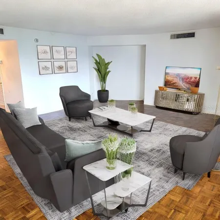 a living room with furniture a couch and a potted plant