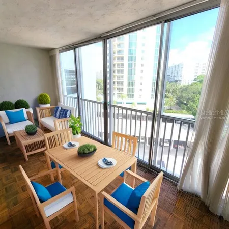 a view of a dining room with furniture a rug and wooden floor