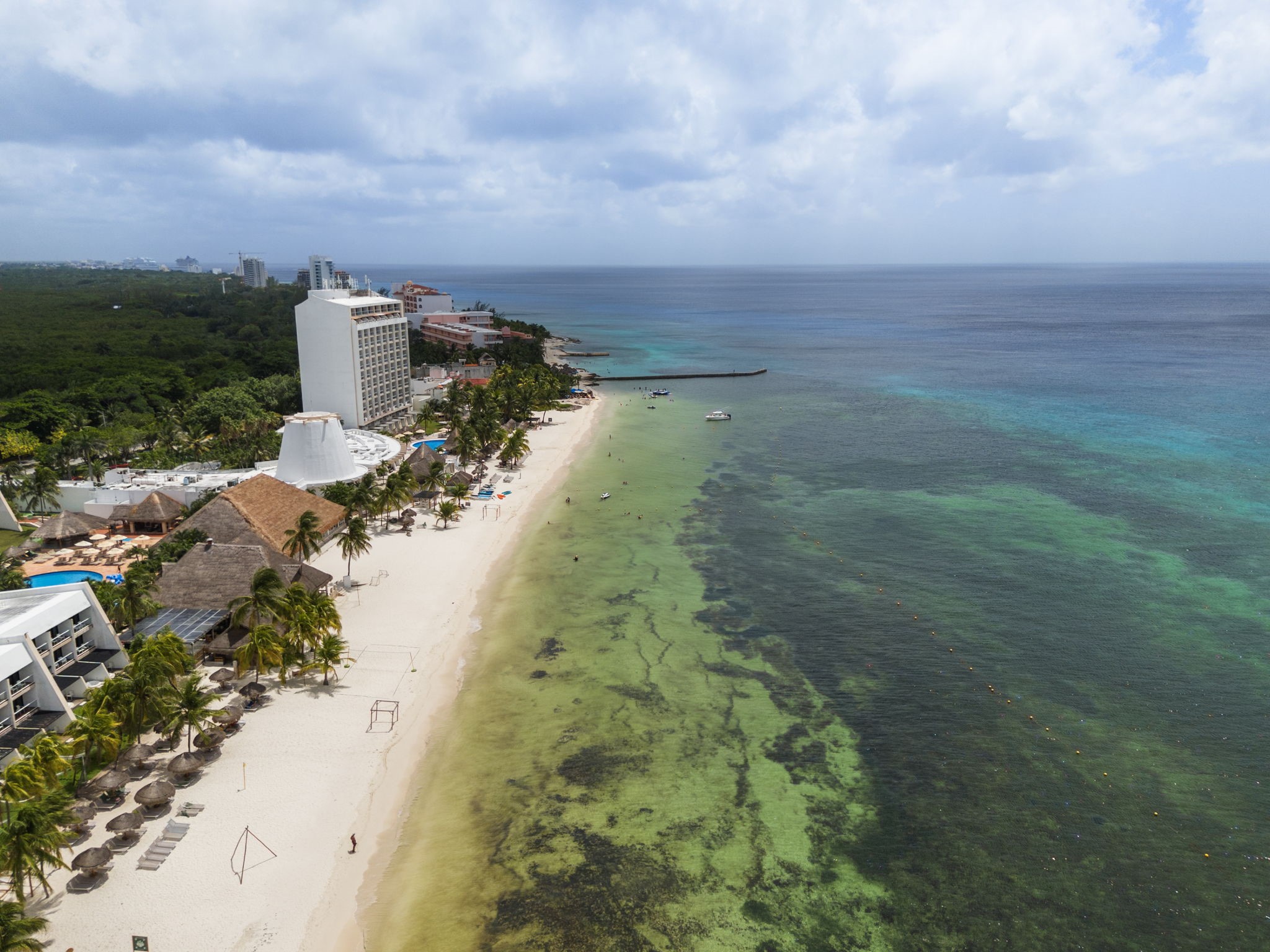 6 Country Club, Unit 4 Nome, TX 77629 - Photo 39 of 45 This exceptional coastal view features the luxurious beach resort district of Cozumel, showcasing a prime stretch of pristine white sand and vibrant turquoise water.