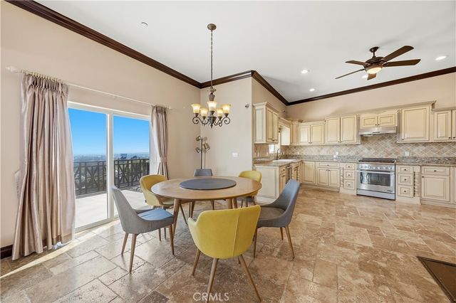a view of a dining room with furniture and a chandelier